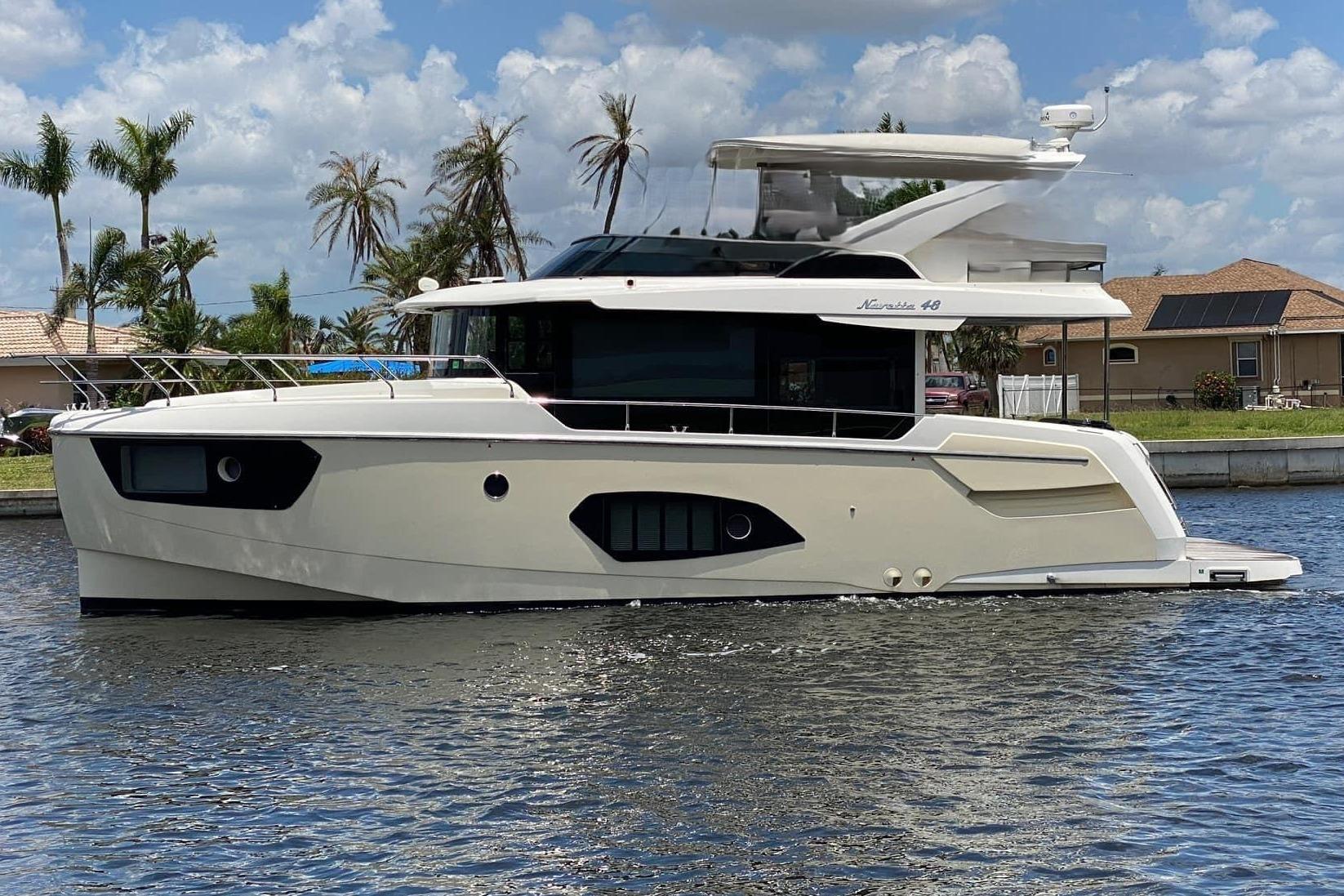 2020 Absolute NAVETTA 48 yacht cruising on a sunny day with blue skies.