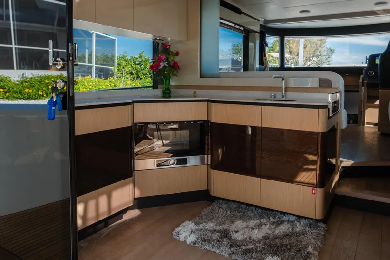  Yacht Photos Pics Luxurious interior of 2020 Absolute 48 Navetta yacht with modern kitchen and seating area.