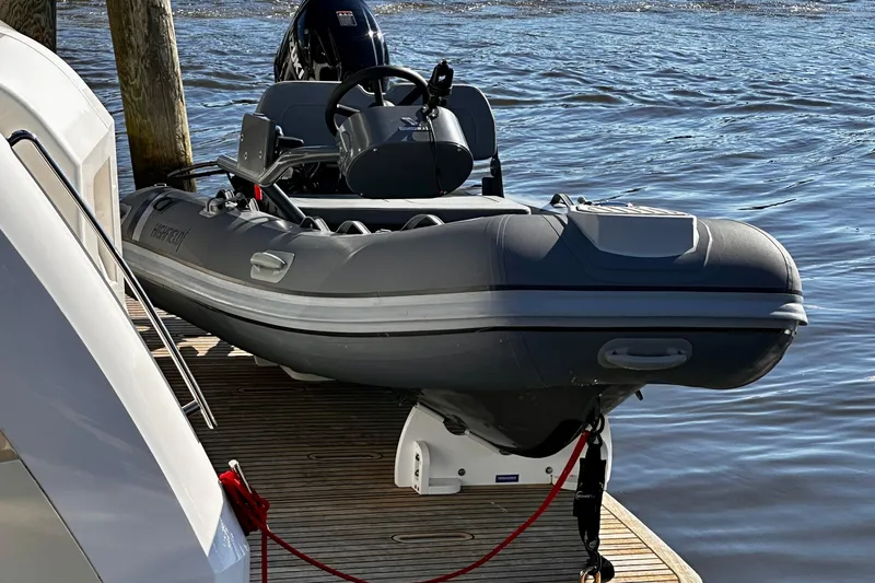  Yacht Photos Pics Inflatable boat docked beside 2020 Absolute NAVETTA 48 yacht on calm water.