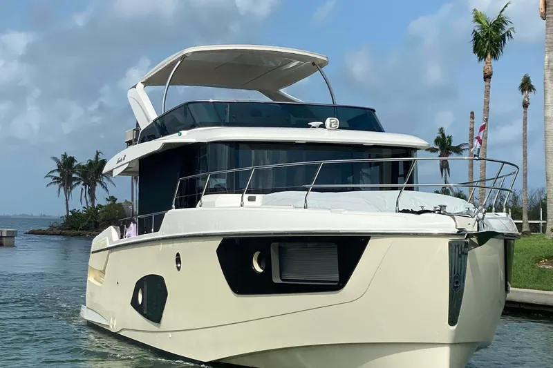  Yacht Photos Pics Luxury Absolute NAVETTA 48 yacht from 2020 cruising near palm trees and blue skies.