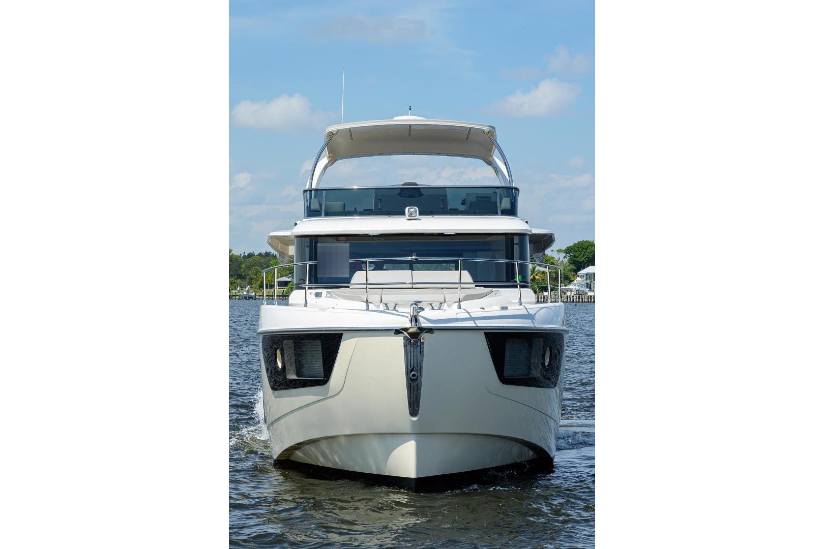 Front view of 2020 Absolute NAVETTA 48 yacht on water under blue sky.