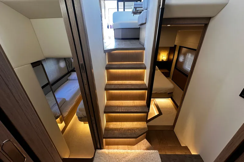  Yacht Photos Pics Luxurious interior of 2020 Absolute NAVETTA 48 yacht with elegant wooden stairs and cozy cabins.