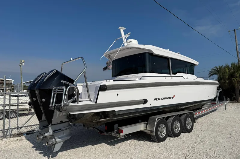  Yacht Photos Pics 2023 Axopar 37 XC CROSS CABIN boat on trailer, featuring dual Mercury engines.