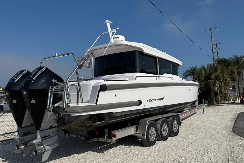  Yacht Photos Pics 2023 Axopar 37 XC CROSS CABIN boat on trailer, featuring twin Mercury engines.