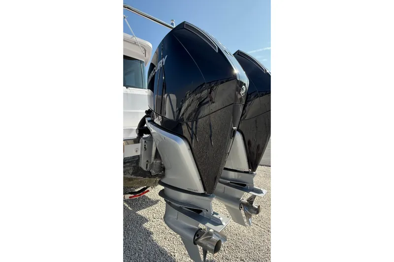  Yacht Photos Pics Twin Mercury outboard engines on 2023 Axopar 37 XC CROSS CABIN boat, parked on gravel.