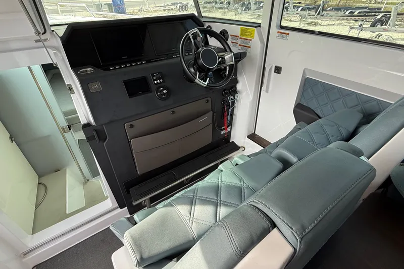  Yacht Photos Pics Interior of 2023 Axopar 37 XC CROSS CABIN, featuring modern helm and seating.