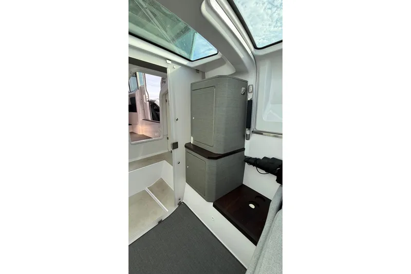  Yacht Photos Pics Interior of 2023 Axopar 37 XC CROSS CABIN, featuring modern cabinetry and skylight.