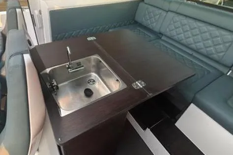  Yacht Photos Pics 2023 Axopar 37 XC CROSS CABIN interior with sink and seating area.