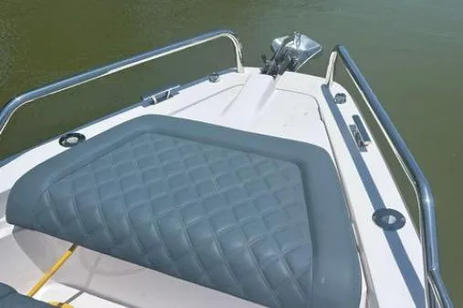  Yacht Photos Pics 2023 Axopar 37 XC CROSS CABIN boat bow with cushioned seating and stainless steel railings.