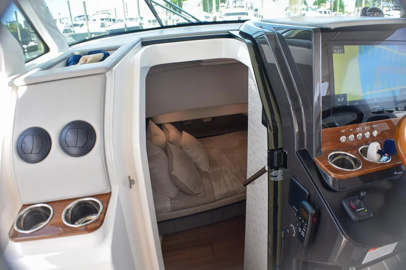 Str8to Yacht Photos Pics 2025 Tiara Yachts 43 LS cabin interior with helm, navigation screen, and cozy sleeping area.