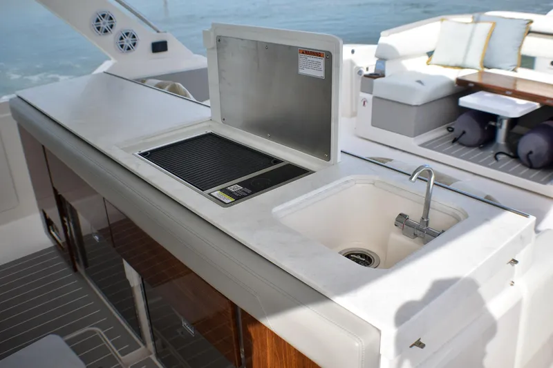 Str8to Yacht Photos Pics Luxury outdoor kitchen on 2025 Tiara Yachts 43 LS, featuring sink and grill.