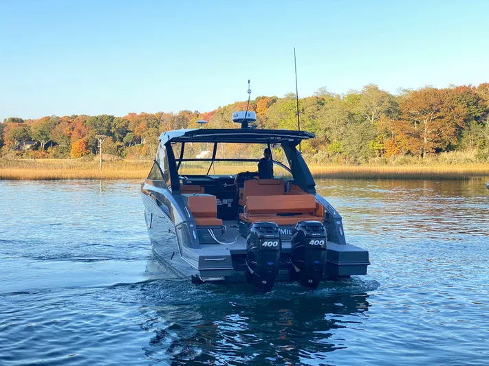  Yacht Photos Pics 2023 Cruisers Yachts 34 GLS OB on serene lake with autumn foliage.