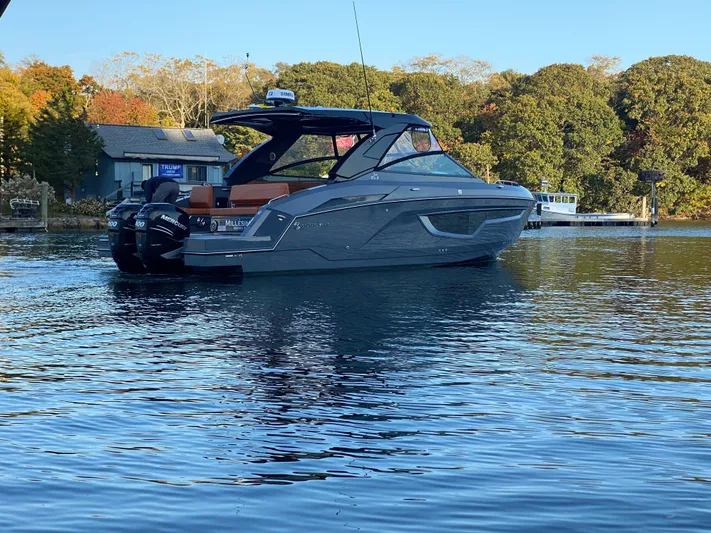  Yacht Photos Pics 2023 Cruisers Yachts 34 GLS OB on serene water with autumn backdrop.