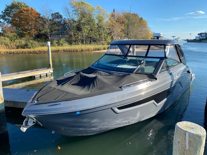  Yacht Photos Pics 2023 Cruisers Yachts 34 GLS OB docked in a serene marina setting.