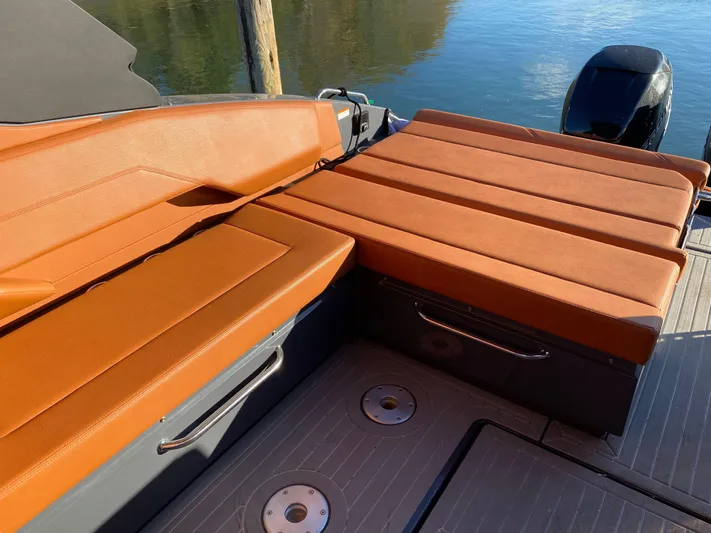  Yacht Photos Pics 2023 Cruisers Yachts 34 GLS OB with orange seating, docked by the water.