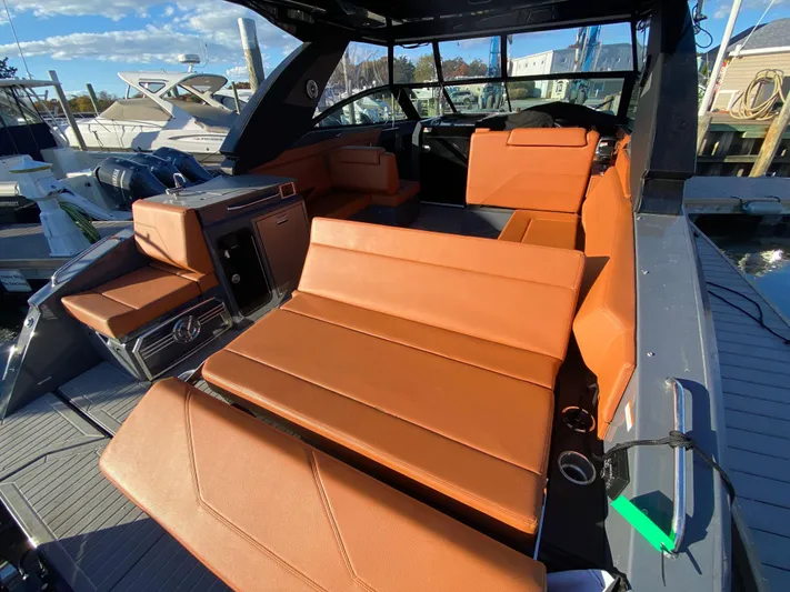  Yacht Photos Pics 2023 Cruisers Yachts 34 GLS OB interior with orange seating and modern design.