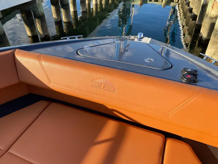  Yacht Photos Pics 2023 Cruisers Yachts 34 GLS OB boat interior with orange seating near dock.