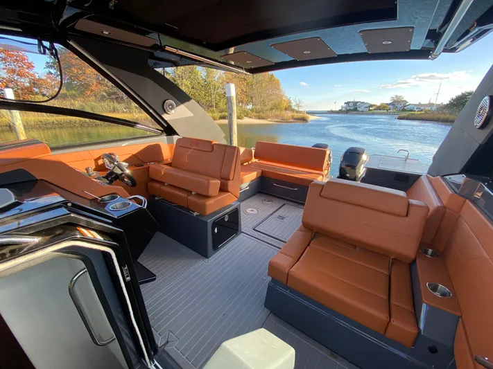  Yacht Photos Pics 2023 Cruisers Yachts 34 GLS OB interior with luxurious seating and scenic waterway view.