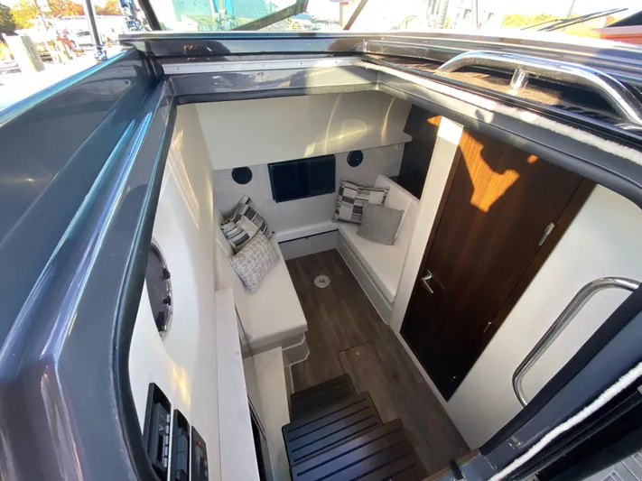 Yacht Photos Pics 2023 Cruisers Yachts 34 GLS OB cabin interior with modern seating and wood accents.