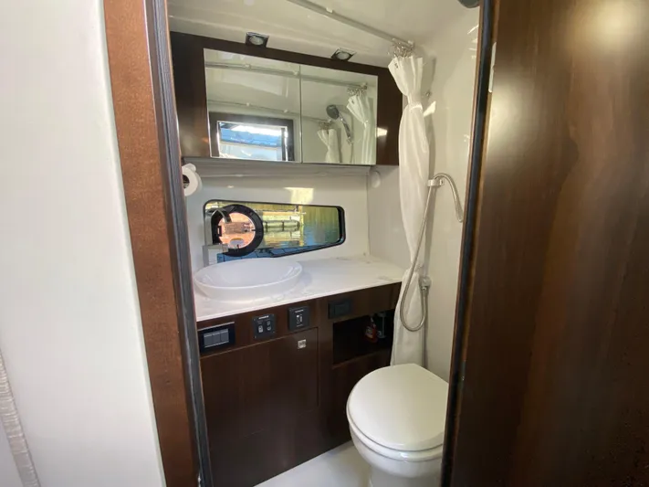  Yacht Photos Pics 2023 Cruisers Yachts 34 GLS OB bathroom with modern fixtures and wood accents.