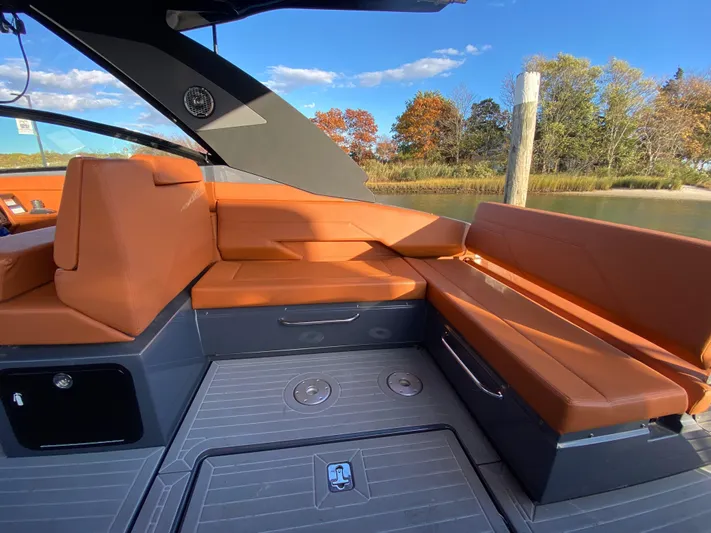  Yacht Photos Pics 2023 Cruisers Yachts 34 GLS OB interior with orange seating, docked by autumn trees.