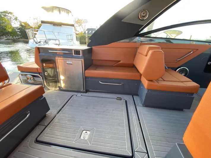  Yacht Photos Pics 2023 Cruisers Yachts 34 GLS OB interior with orange seating and sleek design.