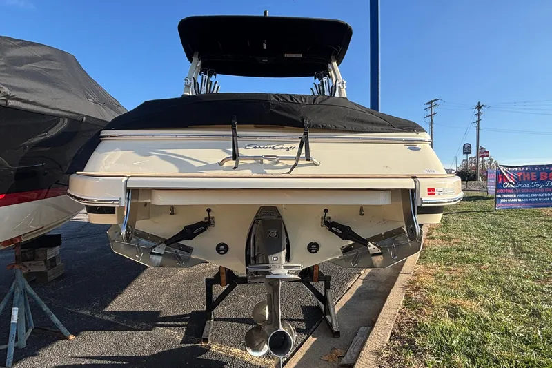  Yacht Photos Pics 2026 Chris-Craft Sportster 28 boat, rear view, parked outdoors on a sunny day.