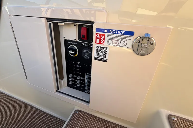  Yacht Photos Pics Control panel of 2026 Chris-Craft Sportster 28 boat with safety notice and QR code.