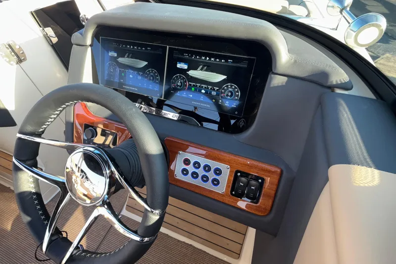  Yacht Photos Pics 2026 Chris-Craft Sportster 28 dashboard with modern steering wheel and digital display.