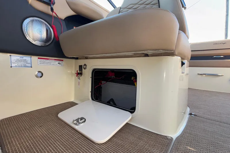  Yacht Photos Pics 2026 Chris-Craft Sportster 28 interior showing storage compartment under seat.