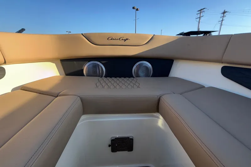  Yacht Photos Pics Luxurious interior of 2026 Chris-Craft Sportster 28 boat with beige seating and speakers.