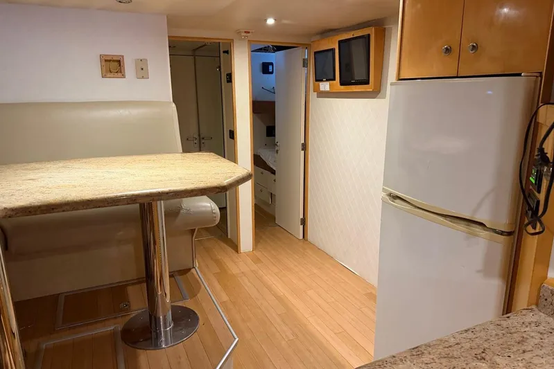  Yacht Photos Pics Interior of 1990 Heesen 144 yacht with dining area, fridge, and hallway view.