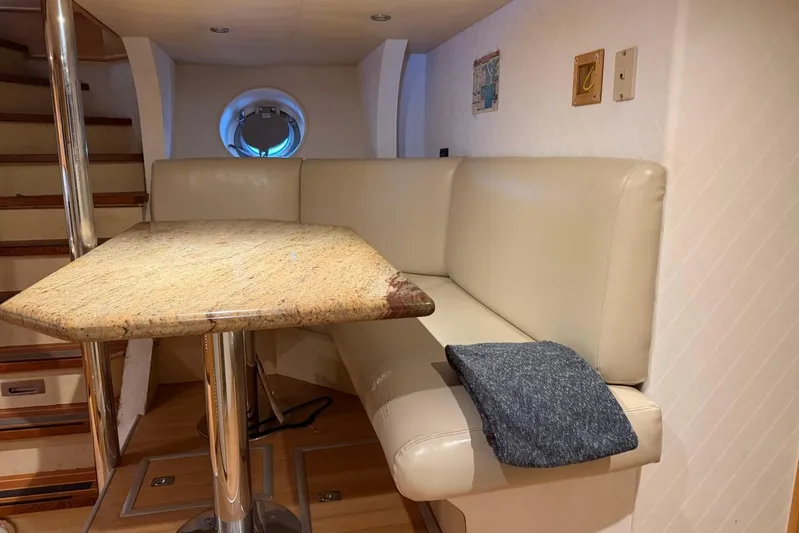  Yacht Photos Pics Luxurious Heesen 144 yacht interior with beige seating and granite table, 1990 model.