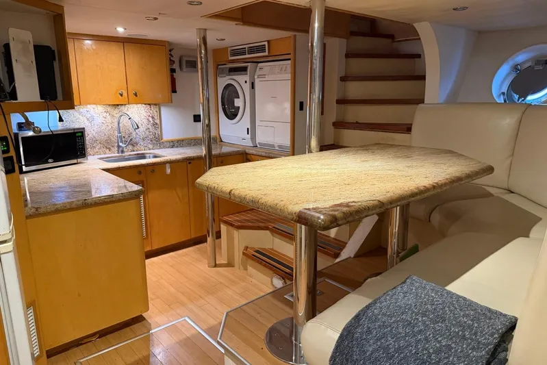  Yacht Photos Pics Luxurious 1990 Heesen 144 yacht interior with kitchen, dining area, and modern amenities.