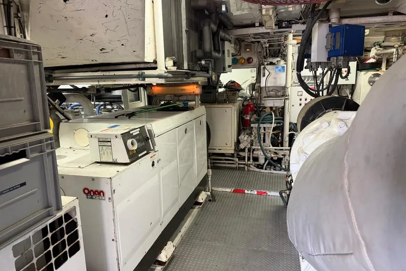  Yacht Photos Pics Engine room of a 1990 Heesen 144 yacht, featuring Onan generator and complex machinery.