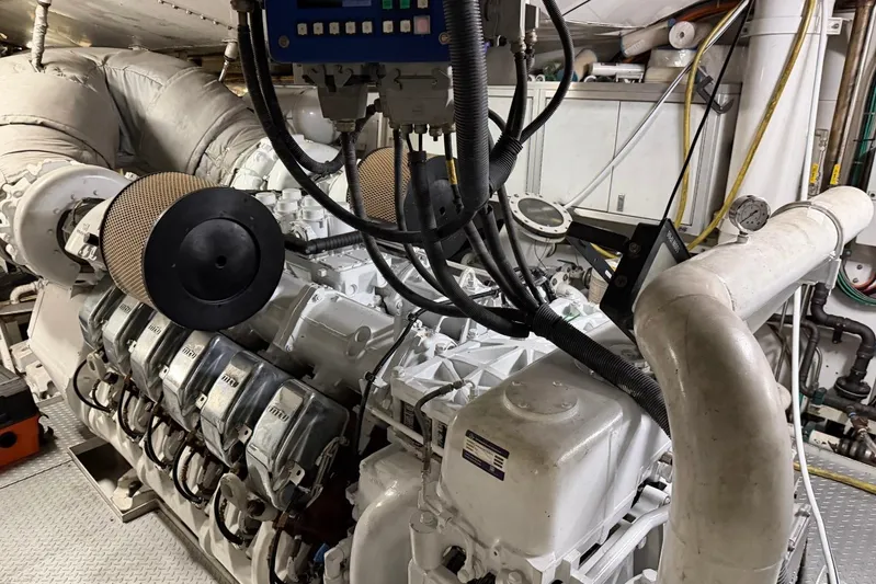  Yacht Photos Pics Engine room of a 1990 Heesen 144 yacht, showcasing complex machinery and piping.