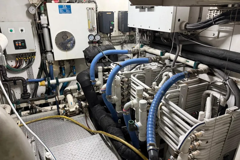  Yacht Photos Pics Engine room of a 1990 Heesen 144 yacht with complex piping and machinery.