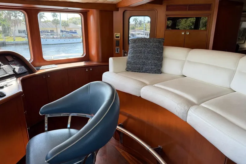  Yacht Photos Pics Luxurious interior of 1990 Heesen 144 yacht with plush seating and scenic window view.