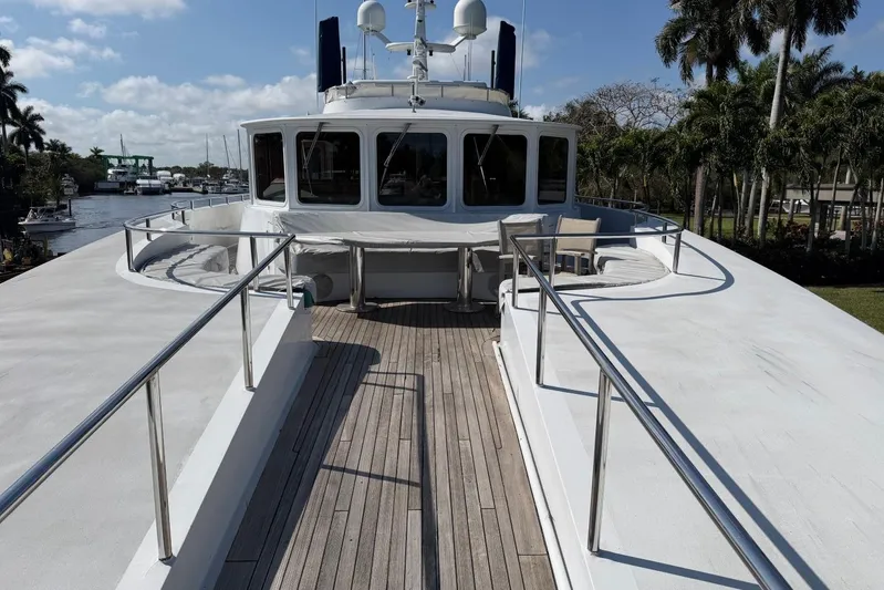  Yacht Photos Pics Luxury Heesen 144 yacht deck, 1990 model, with sleek design and scenic waterway view.
