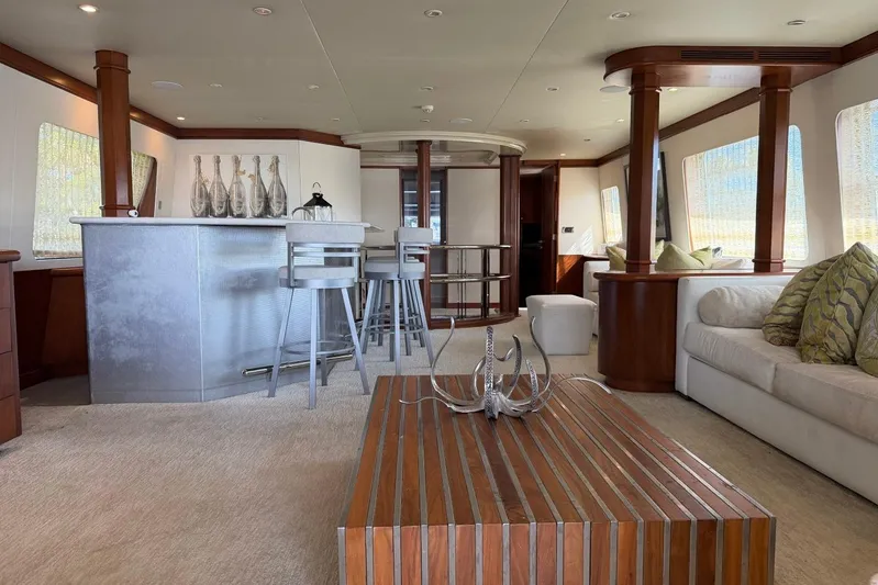  Yacht Photos Pics Luxurious interior of 1990 Heesen 144 yacht with modern bar and elegant seating area.