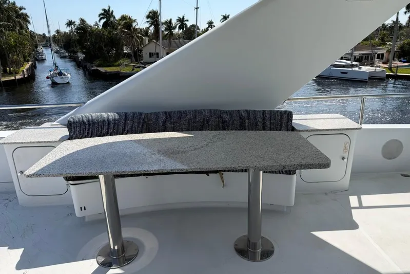  Yacht Photos Pics Luxury yacht Heesen 144 (1990) deck with granite table and waterfront view.