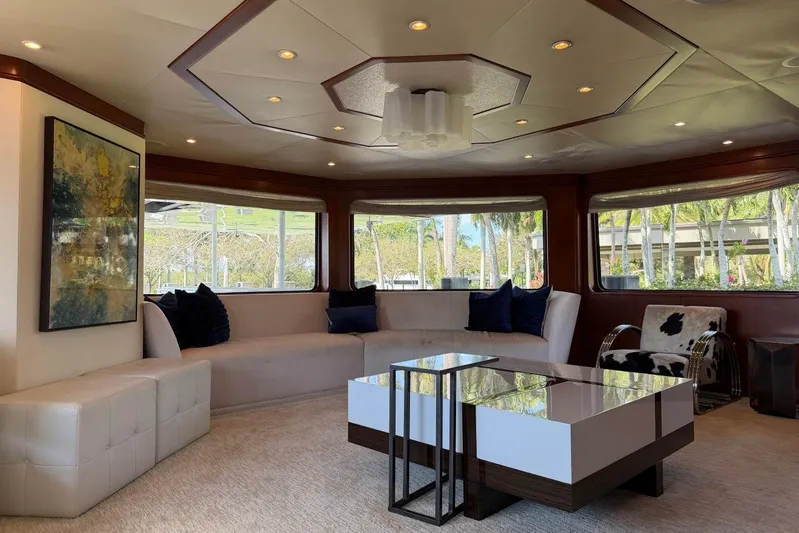  Yacht Photos Pics Luxurious interior of 1990 Heesen 144 yacht with modern furnishings and large windows.