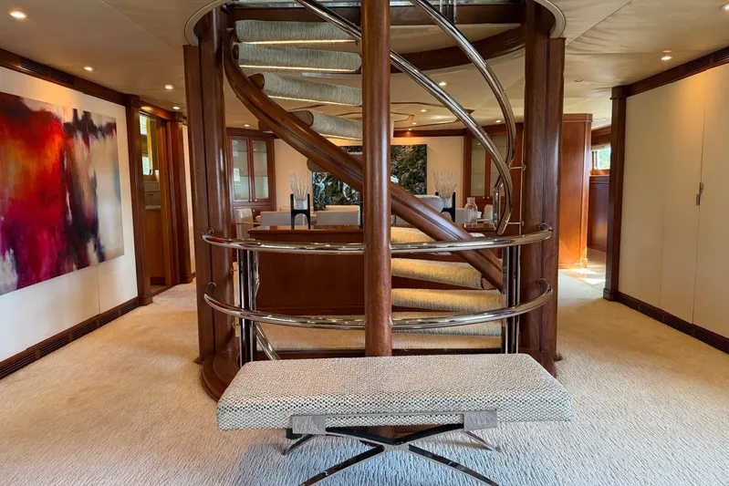  Yacht Photos Pics Luxurious interior of 1990 Heesen 144 yacht with elegant spiral staircase and modern art.