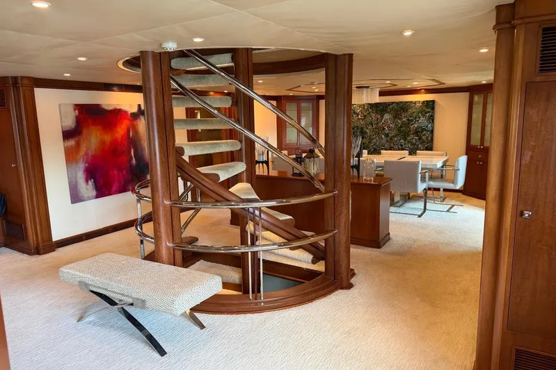  Yacht Photos Pics Luxurious interior of 1990 Heesen 144 yacht with spiral staircase and modern decor.