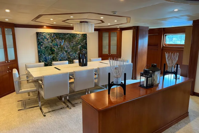  Yacht Photos Pics Luxurious dining area on a 1990 Heesen 144 yacht with elegant decor and modern furnishings.