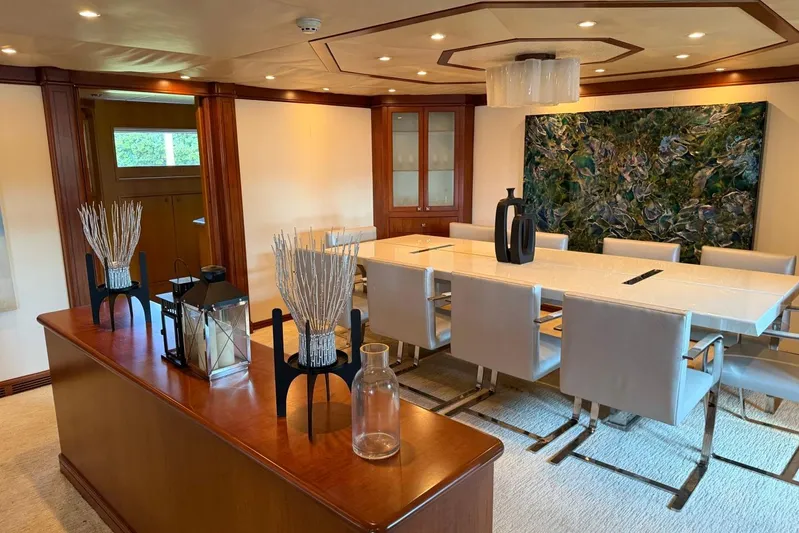  Yacht Photos Pics Luxurious dining area on 1990 Heesen 144 yacht with elegant decor and modern art.
