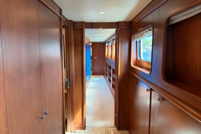  Yacht Photos Pics Luxurious wooden interior hallway of 1990 Heesen 144 yacht, featuring elegant design and windows.