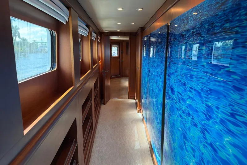  Yacht Photos Pics Luxurious hallway interior of 1990 Heesen 144 yacht with blue wall art.