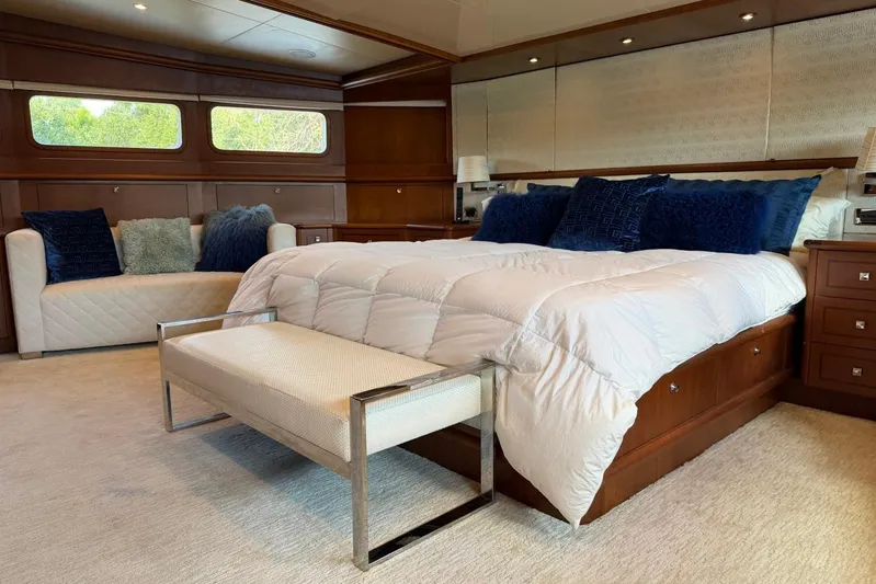  Yacht Photos Pics Luxurious bedroom interior on a 1990 Heesen 144 yacht, featuring elegant bedding and seating.