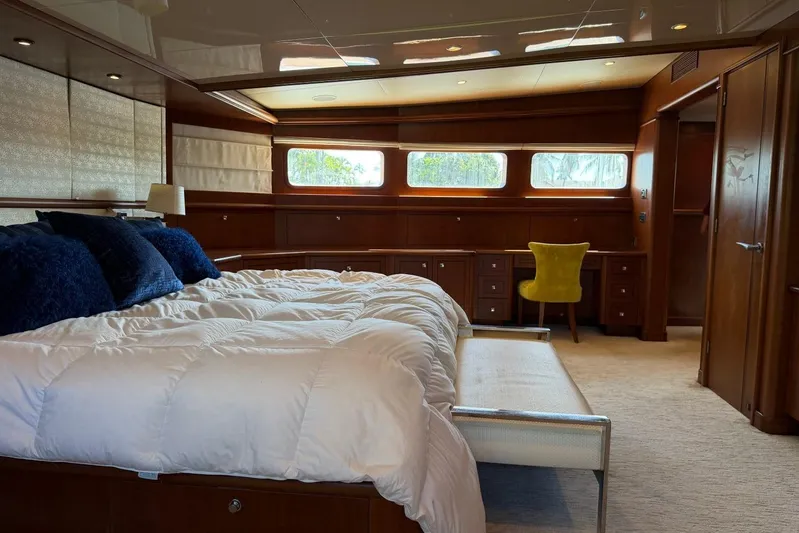  Yacht Photos Pics Luxurious bedroom interior on 1990 Heesen 144 yacht with elegant wood paneling and plush bedding.